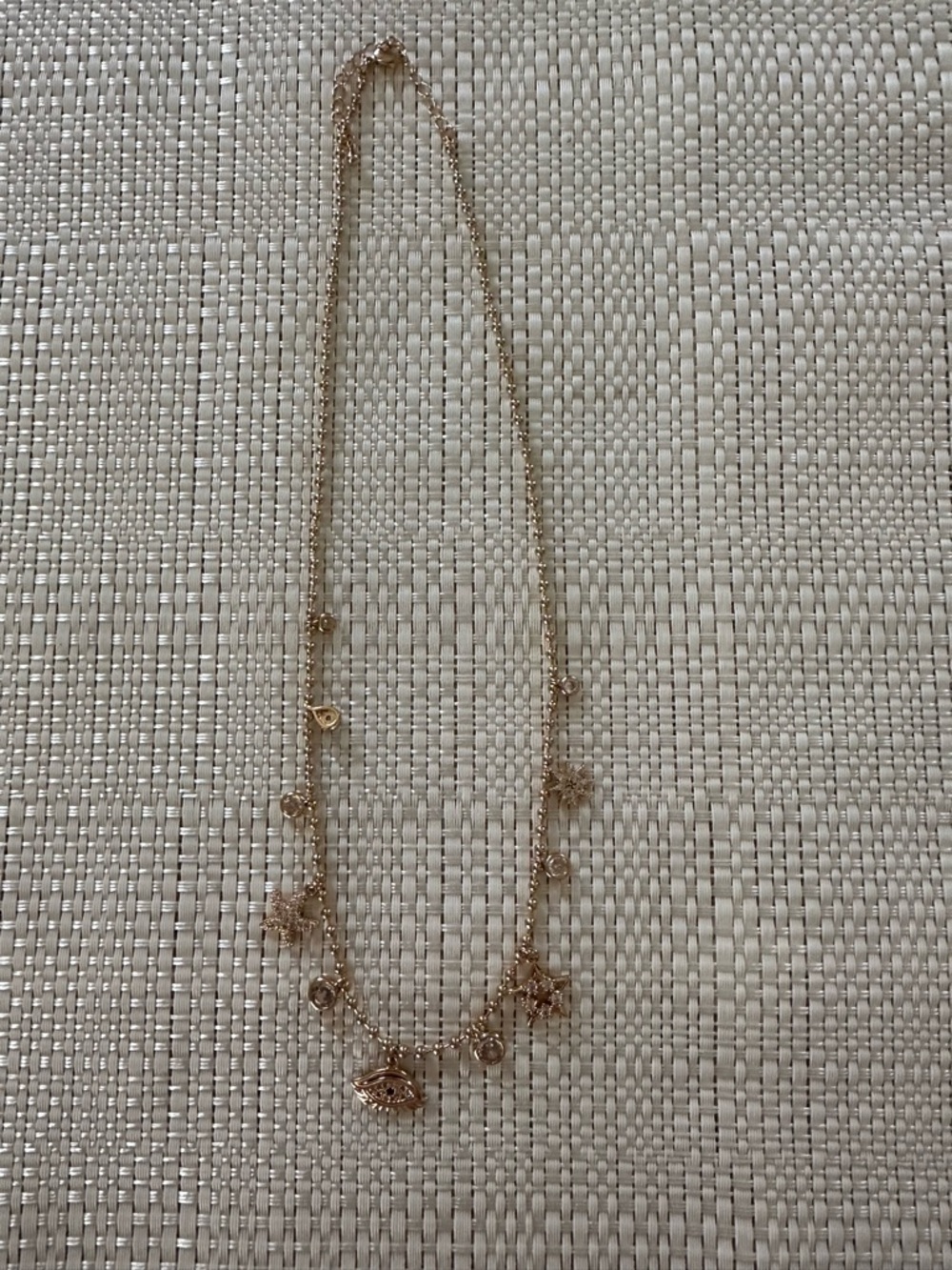 Ladies gold toned charm necklace with evil eye New